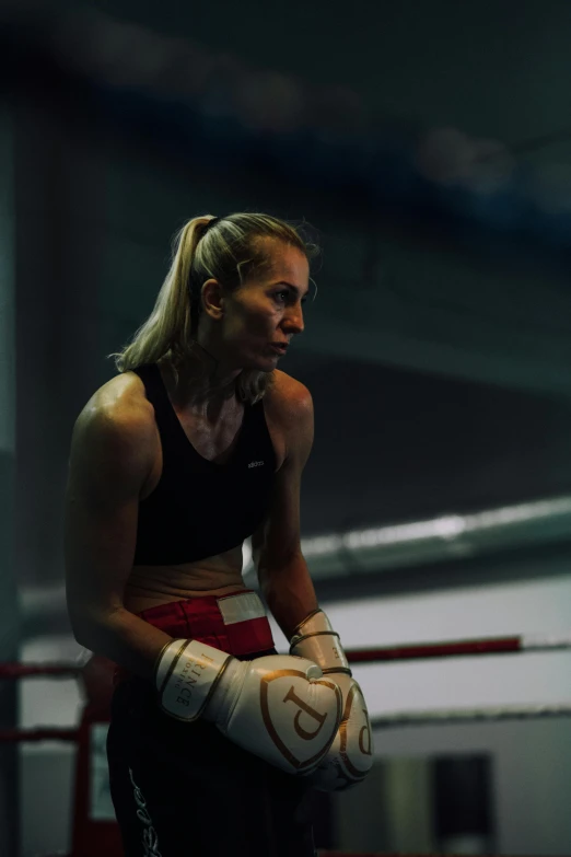 a woman sitting on top of a boxing ring, pexels contest winner, hyperrealism, in a movie still cinematic, britt marling style 3/4, in a gym, dramatic lighting; 4k 8k