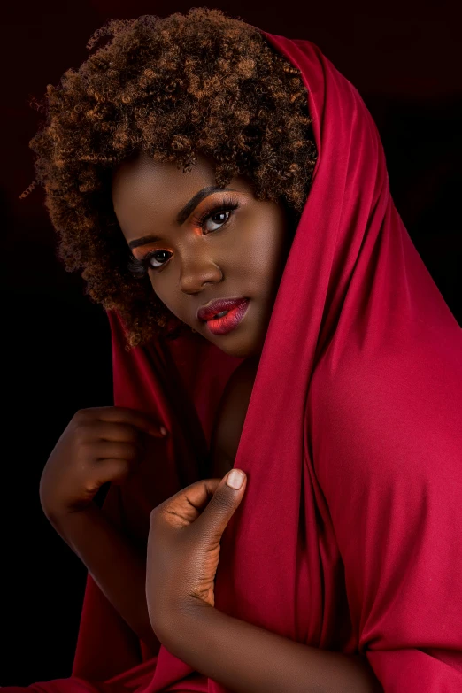 a woman in a red dress posing for a picture, an album cover, by Lily Delissa Joseph, pexels contest winner, brown skin. light makeup, red cloak, low iso, headshot