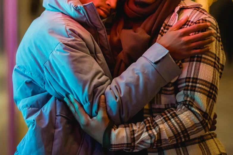 a couple of people that are hugging each other, by Julia Pishtar, hurufiyya, cold lighting, multicoloured, diverse, person