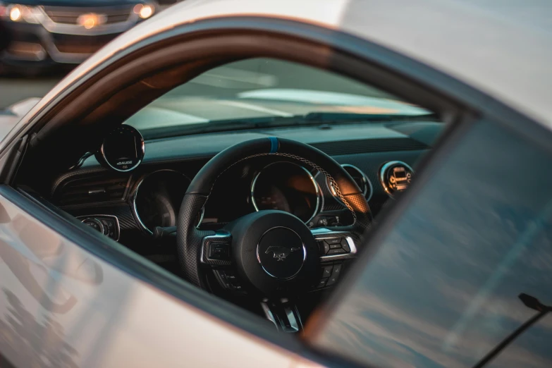 a close up of a car's dashboard and steering wheel, trending on unsplash, mustang, matte white paint, thumbnail, summer evening