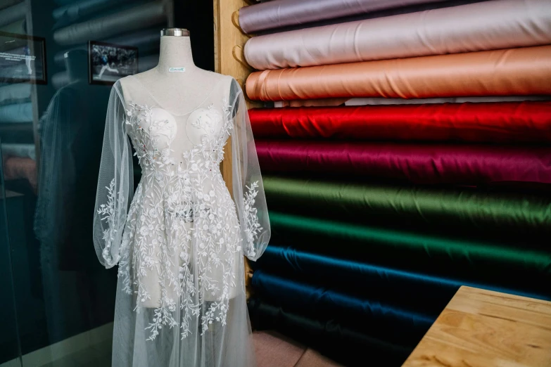 a close up of a dress on a mannequin, by Robbie Trevino, trending on pexels, embroidered robes, various colors, veil, inspect in inventory image