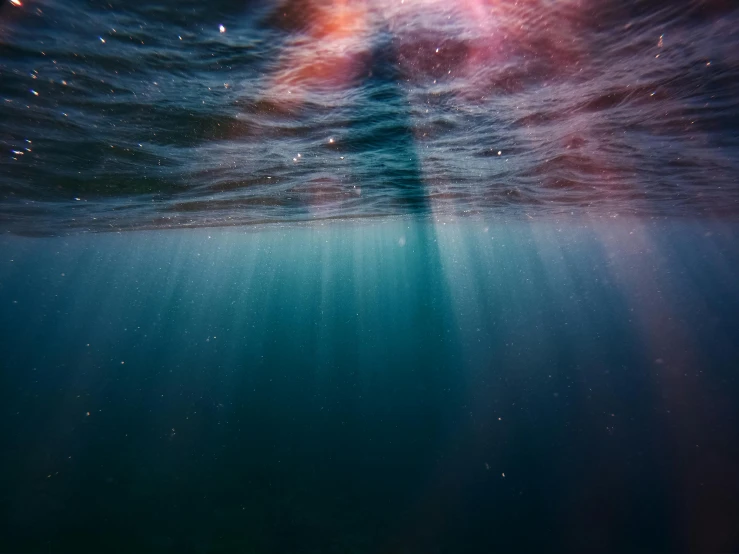 a person standing on a surfboard in the ocean, light and space, swimming deep underwater, instagram post, deep colours. ”, people drowning