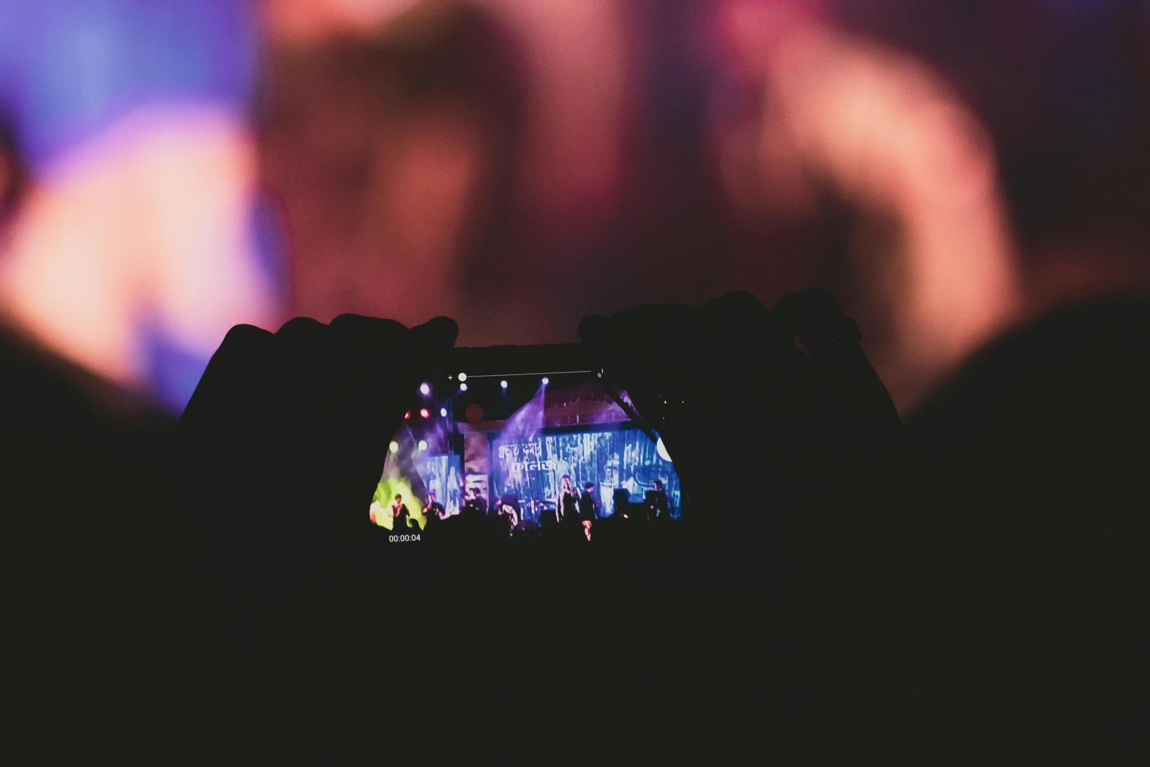 a person taking a picture of a concert, a picture, pexels contest winner, stylized photo, holding it out to the camera, full colour, dark and intricate photograph