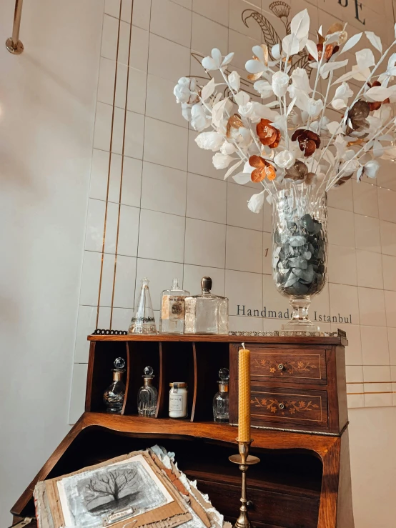 a desk with a vase of flowers on top of it, by Frederik Vermehren, trending on unsplash, art nouveau, with crystals on the walls, high details photo, thumbnail, crafts and souvenirs