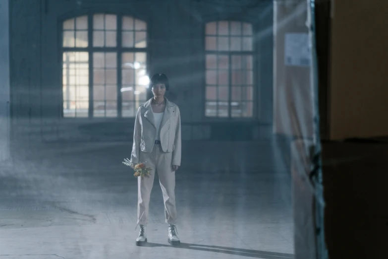 a man holding a baseball bat standing in a room, an album cover, inspired by Feng Zhu, pexels contest winner, magical realism, hologram hovering around her, standing in a large empty hall, still from a music video, shot with sony alpha