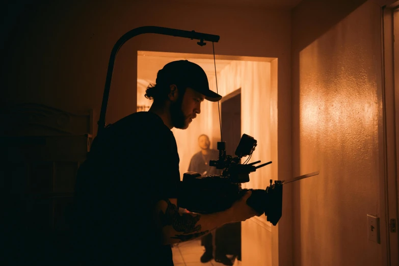 a man standing in a dark room holding a pair of scissors, inspired by roger deakins, pexels contest winner, realism, flares anamorphic, 3 5 mm cooke, instagram picture, crane shot
