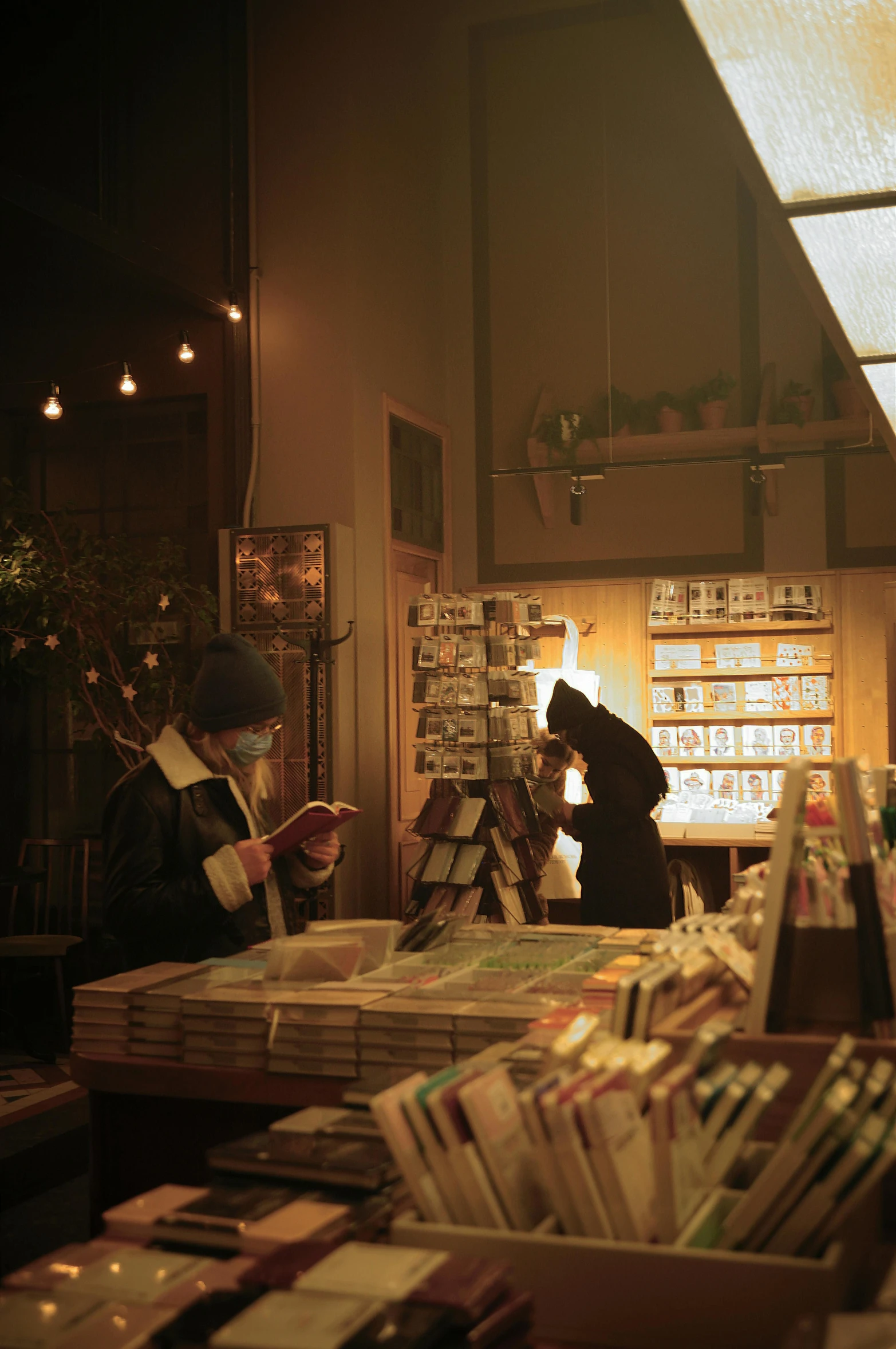 a book store filled with lots of books, an album cover, by Elsa Bleda, unsplash, private press, in a japanese town at night, musician, warm light, live-action archival footage