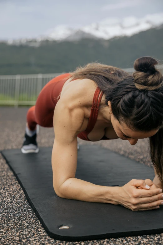 a woman doing push ups on a black mat, by Jessie Algie, pexels contest winner, panoramic view of girl, marked muscles, 6 pack ab, cracks