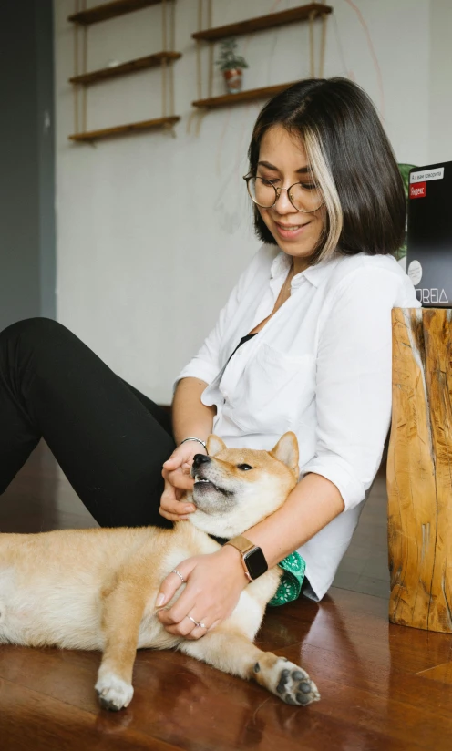 a woman sitting on the floor petting a dog, trending on unsplash, shiba inu face, low quality photo, watch photo, ad image