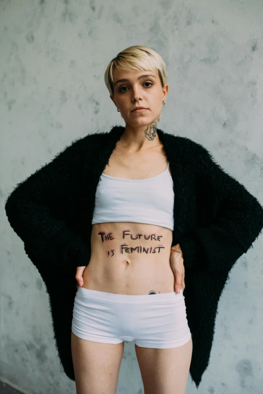 a woman with a tattoo on her stomach, an album cover, inspired by Louisa Matthíasdóttir, trending on pexels, feminist art, portrait of annasophia robb, future activist, futuristic blame, white body