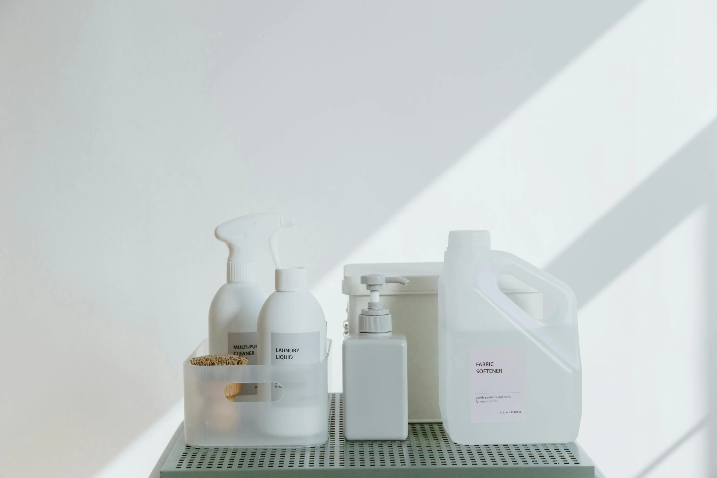 a couple of bottles sitting on top of a shelf, in a white room, utility, sprays, umbra