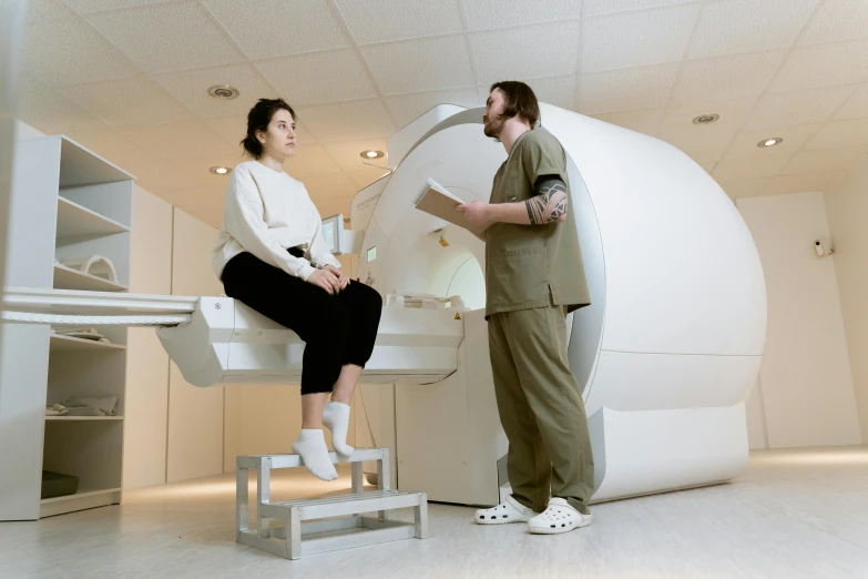 a man and a woman standing in front of a mri machine, pexels contest winner, renaissance, sitting on a table, topographic scan, emma watson with anxious, medical equipment