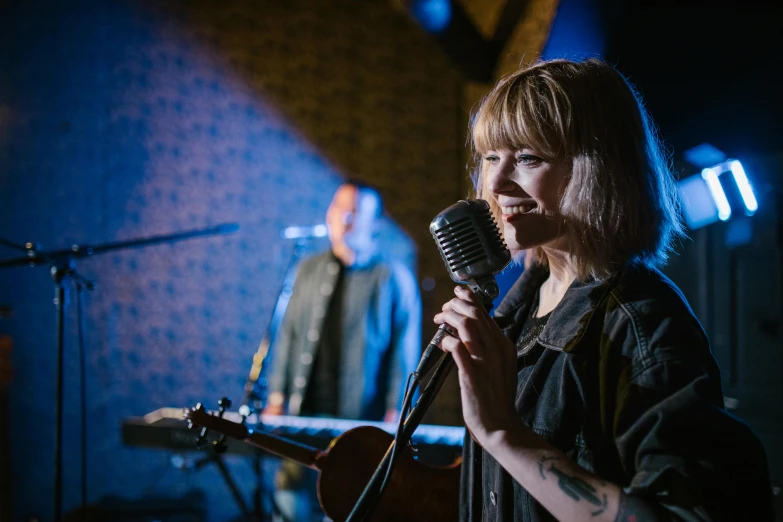 a woman that is standing in front of a microphone, aurora aksnes, frank moth, background bar, profile image