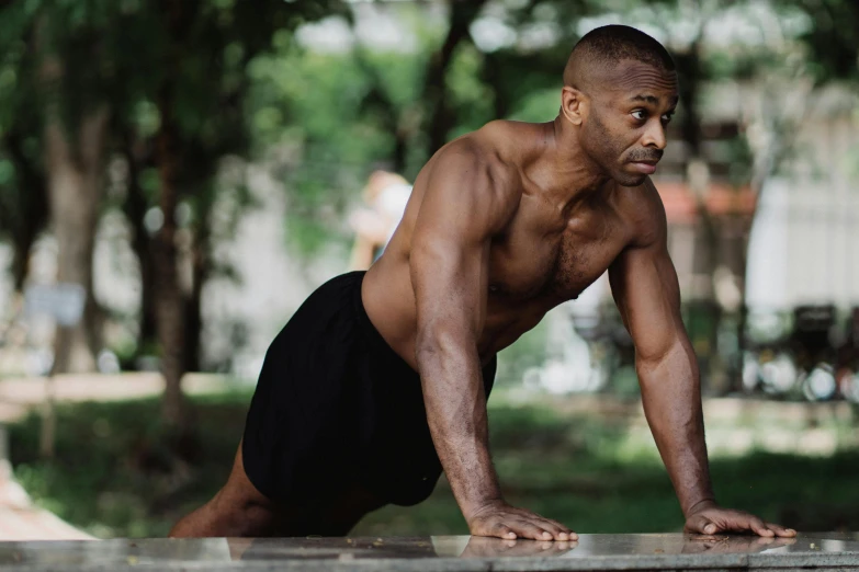 a man doing push ups on a bench in a park, by Carey Morris, pexels contest winner, figuration libre, man is with black skin, mid-shot of a hunky, in a gym, 1980s photo