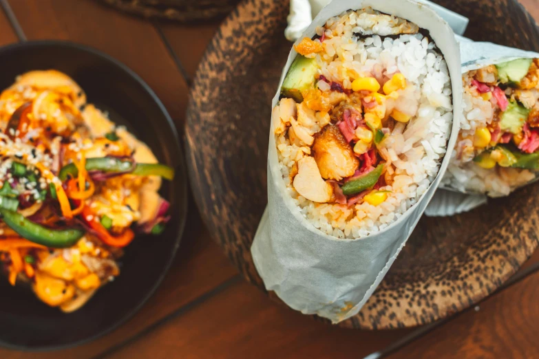 a close up of a plate of food on a table, unsplash, mingei, cloth wraps, background image, chicken, tony taka