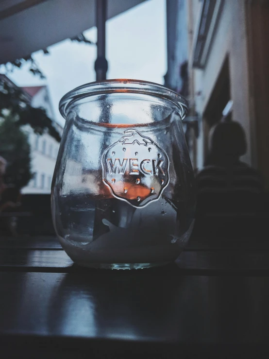 a candle that is sitting on a table, by Daniel Lieske, pexels contest winner, glass jar, trip to legnica, instagram story, promo image