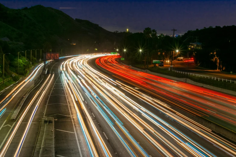 a highway filled with lots of traffic at night, an album cover, unsplash contest winner, southern california, thumbnail, vibrant scattered light, joel fletcher