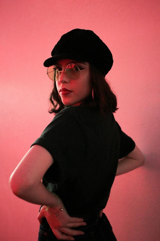 a woman in a hat and glasses poses for a picture, an album cover, inspired by Nan Goldin, trending on pexels, serial art, bisexual lighting, berets, aubrey plaza, ((pink))