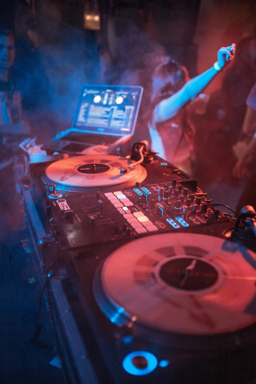 a dj mixing music in front of a laptop, pexels, renaissance, college party, with red haze, photograph of three ravers, turntables