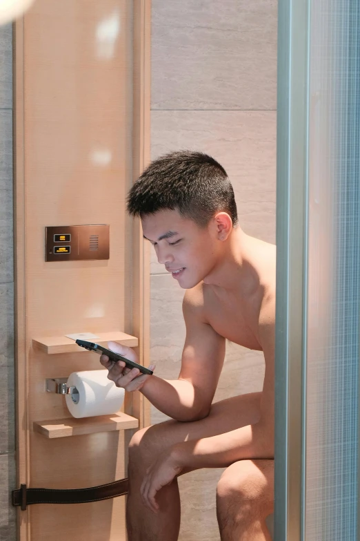 a man sitting on a toilet using a cell phone, a hologram, inspired by Xie Huan, sauna, teen boy, square, gay