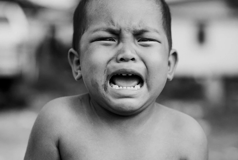 a black and white photo of a young boy crying, by Jan Rustem, pexels contest winner, peruvian boy looking, showing anger, ben lo, album