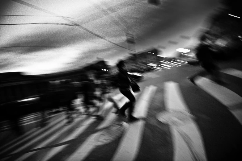 a black and white photo of a person on a skateboard, a black and white photo, by Mirko Rački, night. by greg rutkowski, crowd, motionblur, by joseph binder