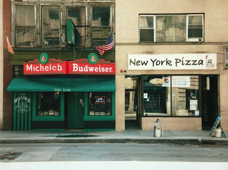 a couple of buildings that are next to each other, a colorized photo, by Richard Estes, unsplash, photorealism, pizza on a table, annie lebowitz, michelin restaurant, 1990s photograph