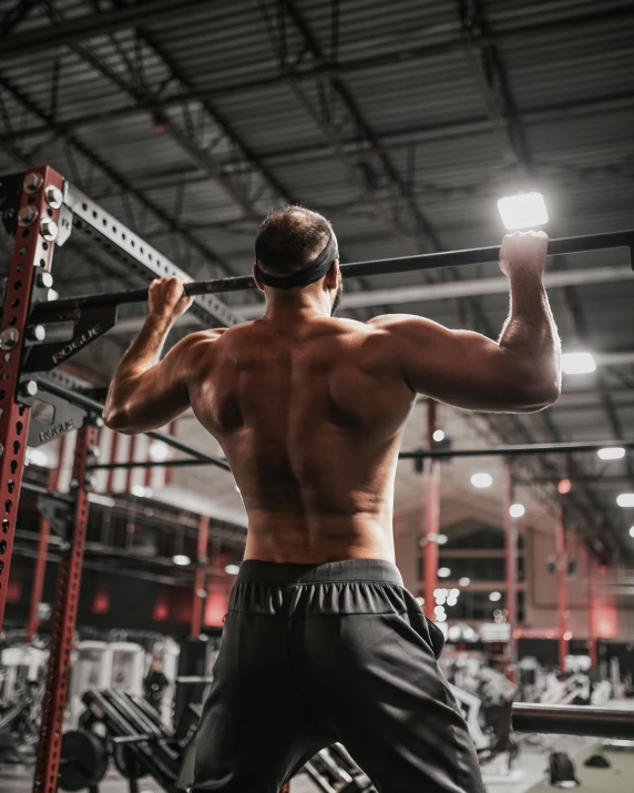 a man doing pull ups in a gym, a screenshot, by Sam Black, pexels contest winner, renaissance, lgbt, back to back, 🚿🗝📝, andrew gonzalez