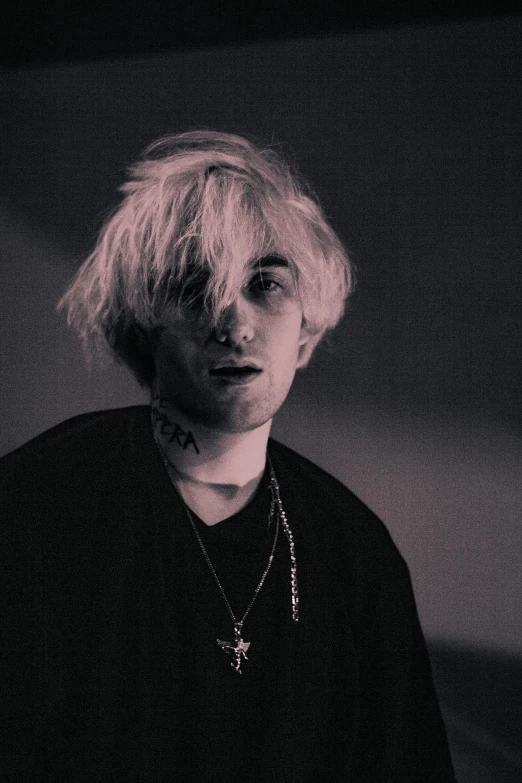 a black and white photo of a person with blonde hair, inspired by Cam Sykes, bladee from drain gang, pale hair, his hair is messy and unkempt, holy glow