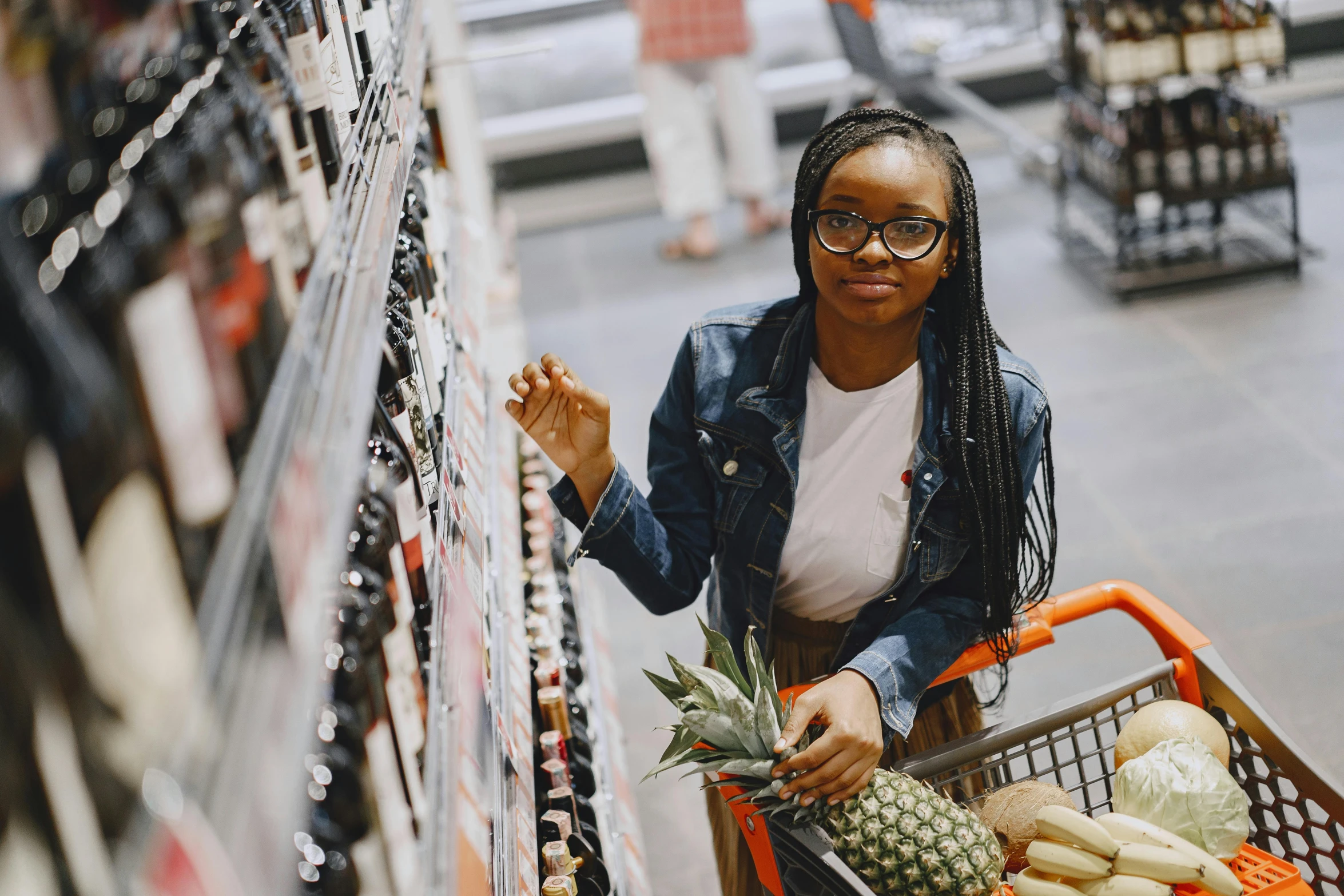 a woman pushing a shopping cart in a grocery store, by Daniel Lieske, pexels contest winner, hyperrealism, black young woman, drink, avatar image