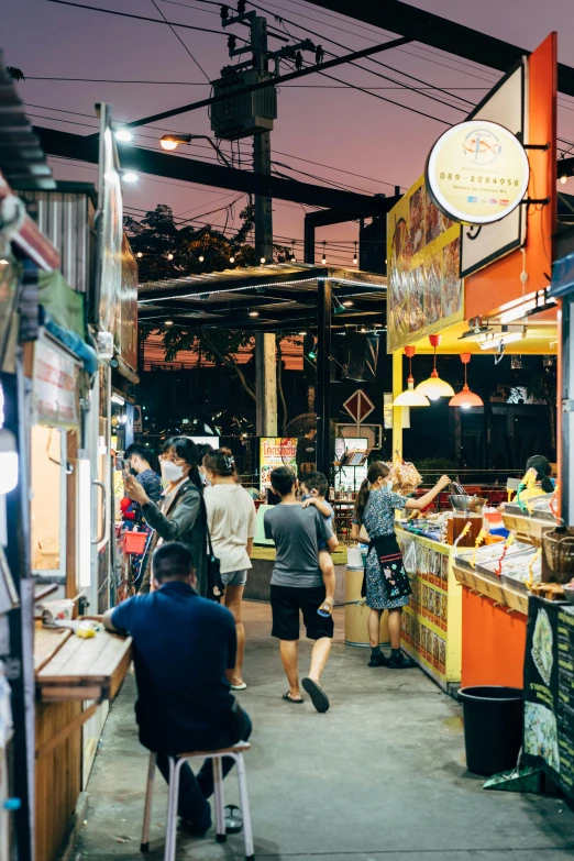 a group of people standing around a food stand, nightlife, quirky shops, beautifully daylight, rectangle