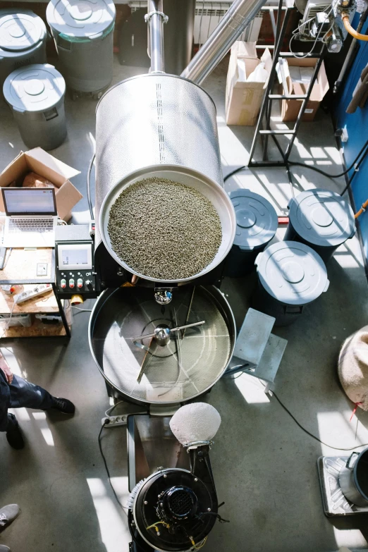 a group of people working in a factory, a photo, by Ben Zoeller, process art, huge cup of coffee, birdseye view, seeds, scientific equipment