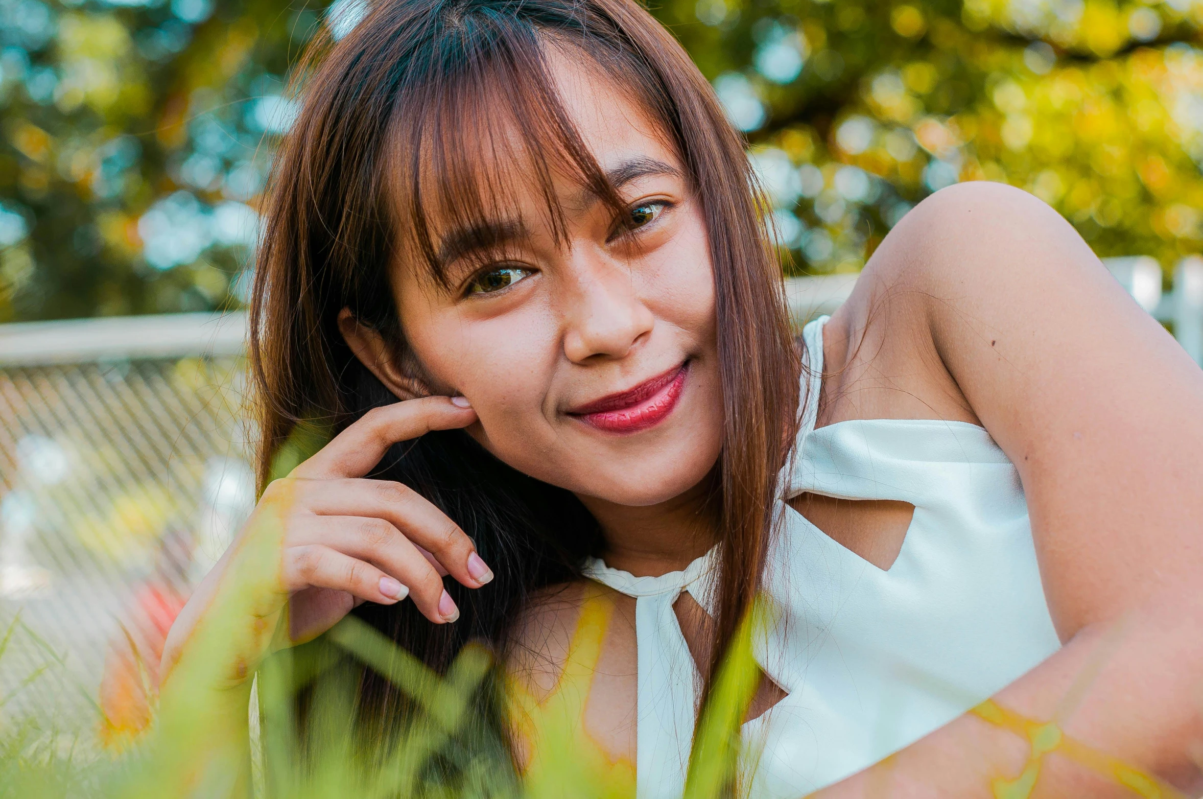 a woman laying in the grass talking on a cell phone, pexels contest winner, south east asian with round face, avatar image, portrait cute-fine-face, headshot profile picture