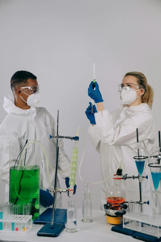 a couple of people standing next to each other in a lab, trending on pexels, analytical art, hazmat, in front of white back drop, gen z, sfx