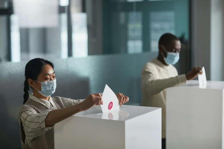 a woman putting a piece of paper into a voting box, a photo, pexels contest winner, happening, masked doctors, square, office ceiling panels, avatar image