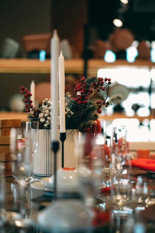 a table that has a bunch of place settings on it, pexels, candles in foreground, red white and black color scheme, restaurant, winter