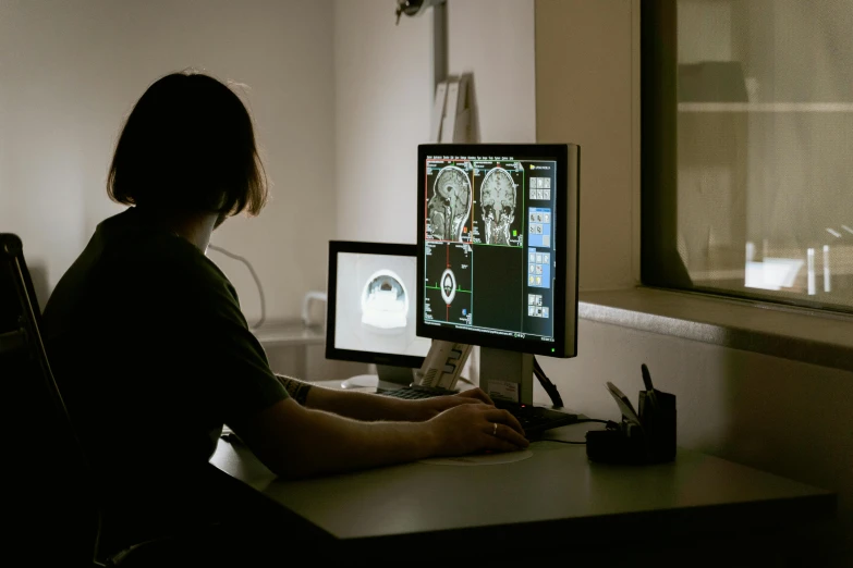 a person sitting at a desk in front of a computer, mri, profile image, alessio albi, null