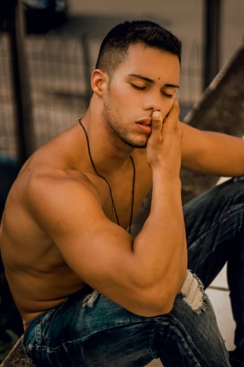 a man sitting on the ground with his eyes closed, by Cosmo Alexander, trending on pexels, realism, mid-shot of a hunky, caio santos, sittin