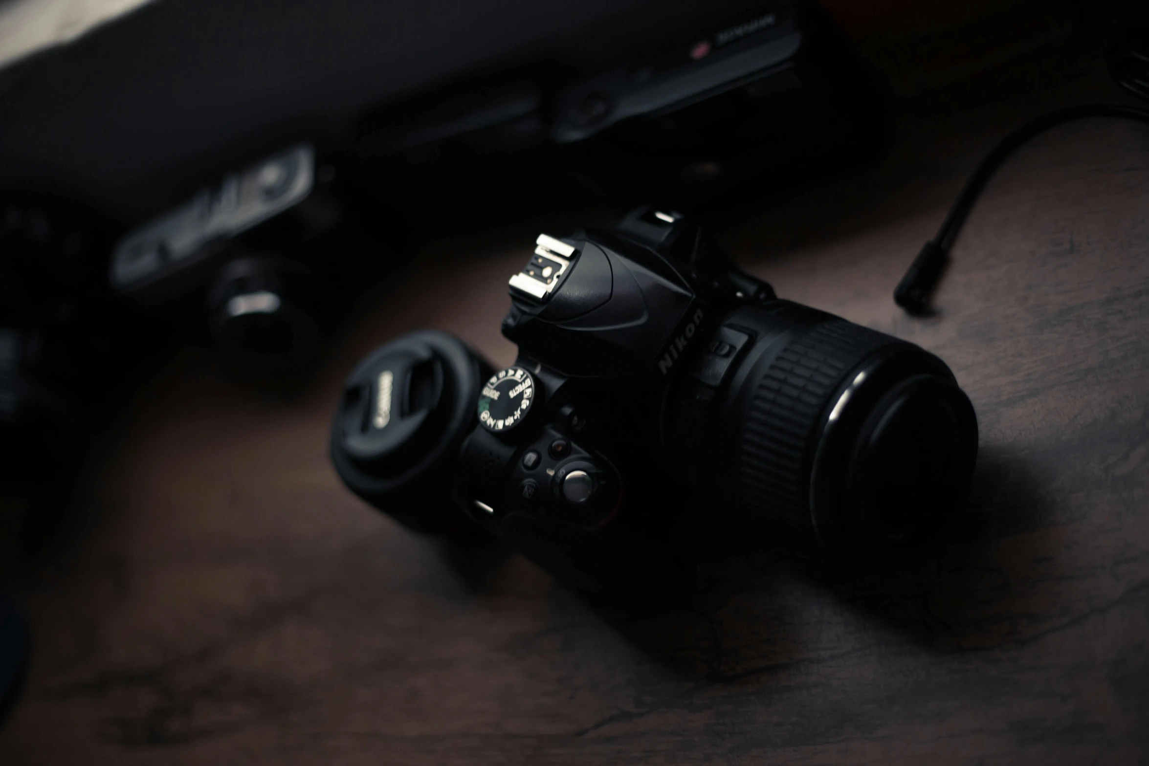 a camera sitting on top of a wooden table, a picture, top selection on unsplash, medium format. soft light, canon 7 d, with nikon cameras