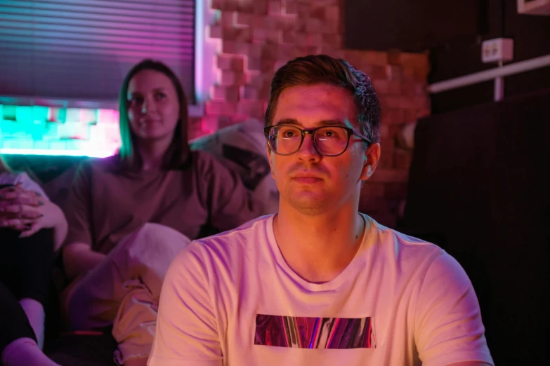 a group of people sitting on top of a couch, by Adam Marczyński, pexels contest winner, realism, cinematic neon uplighting, angry video game nerd, portrait of two people, julian ope