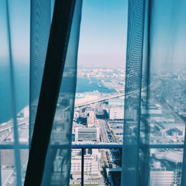 a view of a city from a window, a picture, unsplash contest winner, visual art, winter blue drapery, view of the ocean, skybridge towers, instagram picture