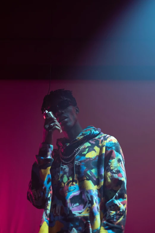 a man standing on top of a stage holding a microphone, an album cover, pexels, visual art, 2 chainz, deep in thought, ( ( dark skin ) ), jean deville
