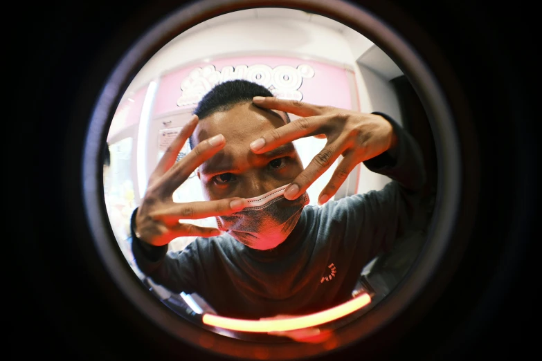 a man taking a picture of himself in a mirror, inspired by NEVERCREW, pexels contest winner, lyco art, ((fish eye)), red neon eyes, mechanic, round window