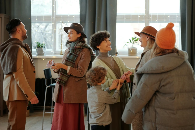 a group of people standing next to each other, by Emma Andijewska, pexels contest winner, arts and crafts movement, caracter with brown hat, joyful people in the house, holiday season, 15081959 21121991 01012000 4k