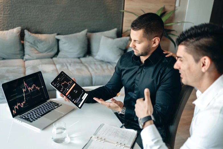 a couple of men sitting at a table with laptops, pexels contest winner, 🦩🪐🐞👩🏻🦳, corporate boss, background image, charts