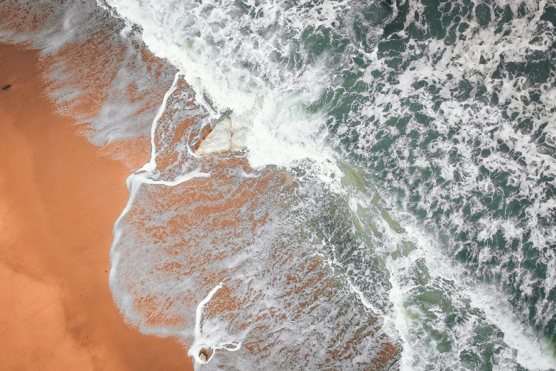 a person riding a surfboard on top of a sandy beach, inspired by Andreas Gursky, unsplash contest winner, generative art, dutch angle from space view, orange and white color scheme, water powers water swirling, south african coast