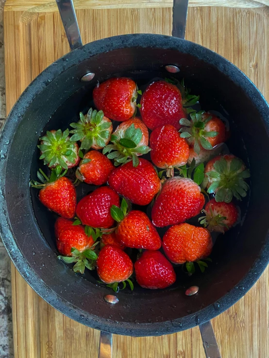 a bowl of strawberries sitting on a cutting board, taken on iphone 1 3 pro, pot, high quality product image”, mid shot photo