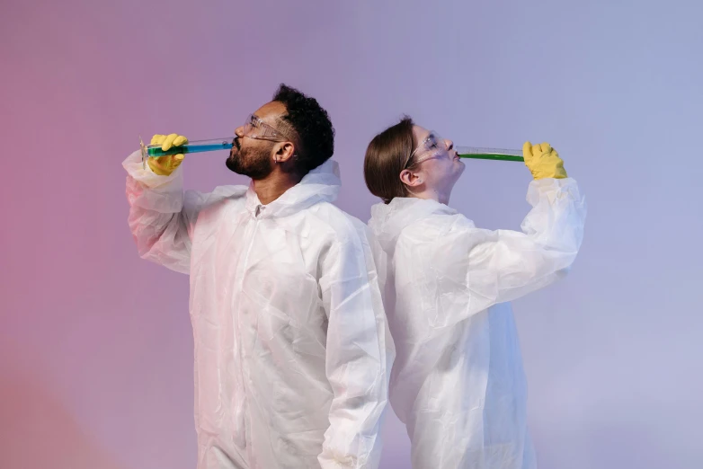 a couple of men standing next to each other, pexels contest winner, process art, test tubes, dabbing, male and female, tech robes