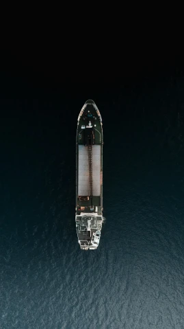 a boat floating in the middle of the ocean, by Dan Christensen, pexels contest winner, lit from above, utilitarian cargo ship, gif, ship in a bottle