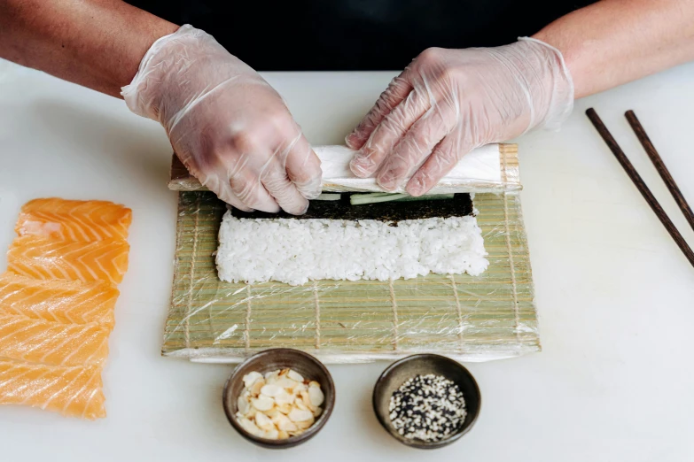 a person in white gloves is making sushi, botanicals, seams, epicurious, ninja scrolls